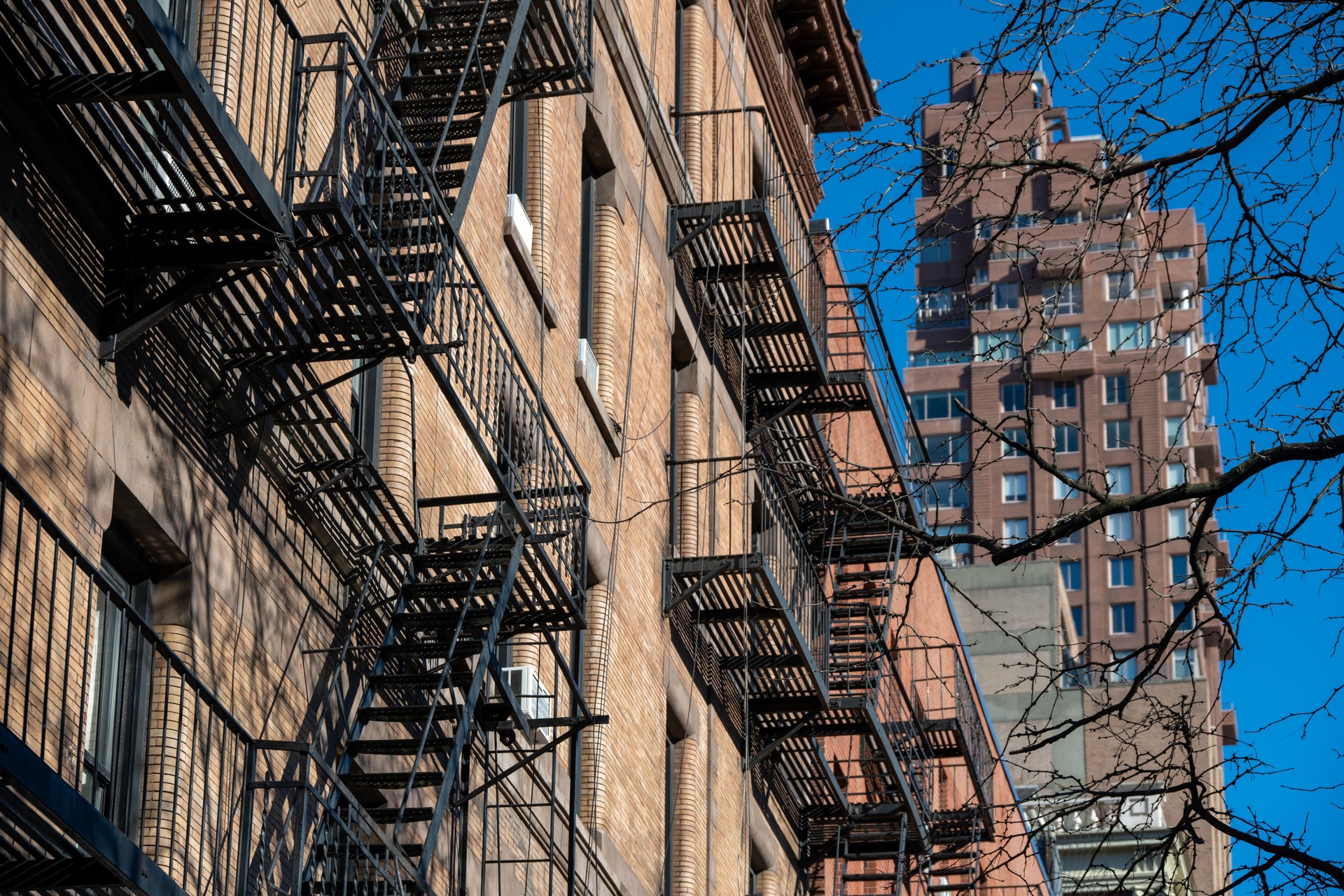 Building facades with fire escapes in New York in winter