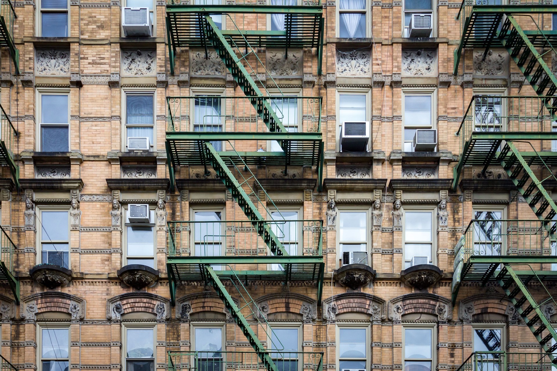 Windows and fire escapes on an old building in Manhattan, New York City